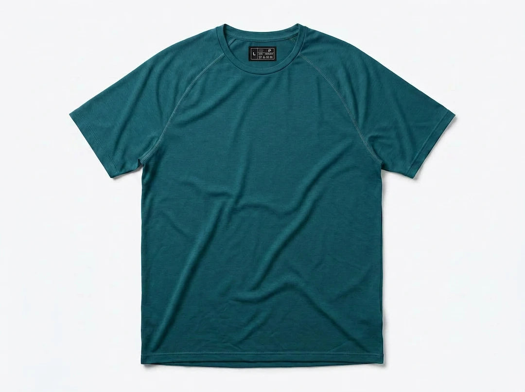 The Draper Tee in teal featuring COOLCORE® cooling technology, raglan sleeves, and a modern athletic fit.