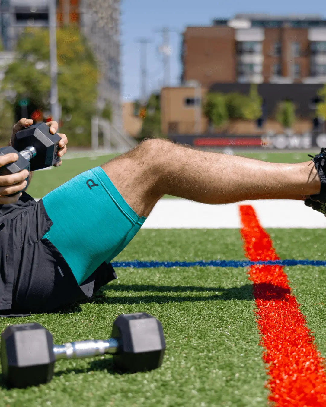 Male athlete resting between sets in blue Pacterra shorts, showing the breathable fabric in action.