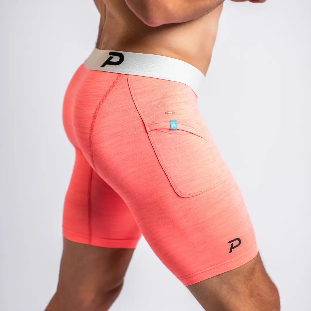 Side view of pink compression shorts showcasing the vibrant color and premium, soft-to-the-touch performance knit.