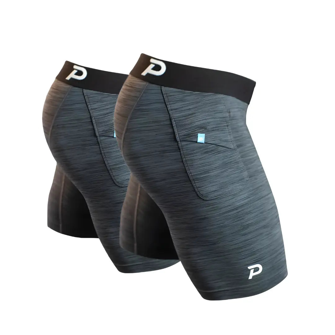Two-pack of Pacterra Middy men's compression shorts in heather grey, featuring ultra-comfortable performance fabric and a secure side pocket for all-day wear.