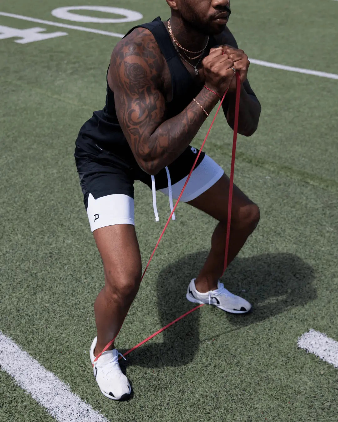 Close-up of white Middy compression shorts during a resistance workout, highlighting the flexible 4-way stretch fabric.