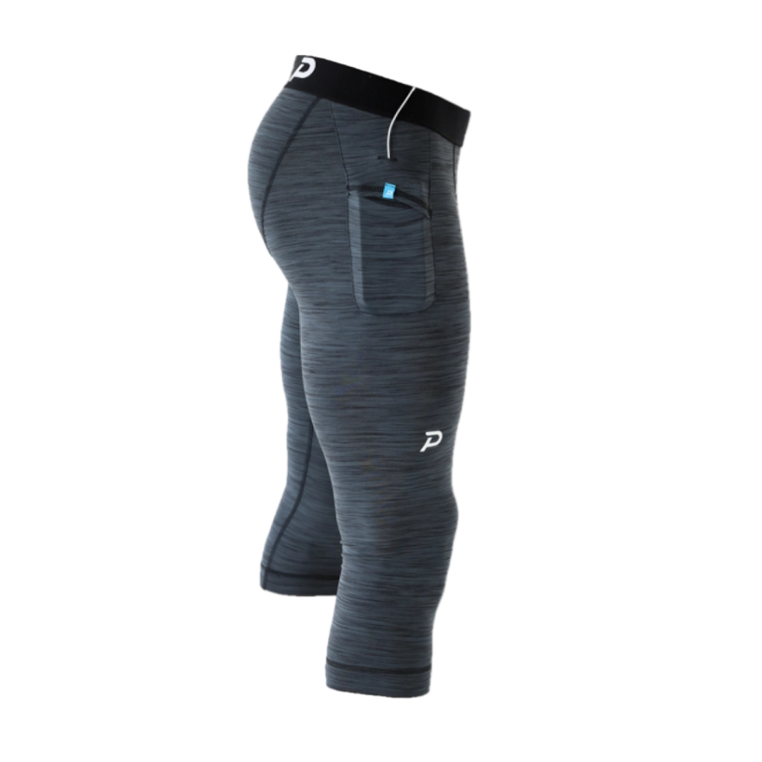 Flat lay view of the Pacterra 3/4 Strider men's compression tight in charcoal grey, showing the premium SwingLoft fabric and build quality.