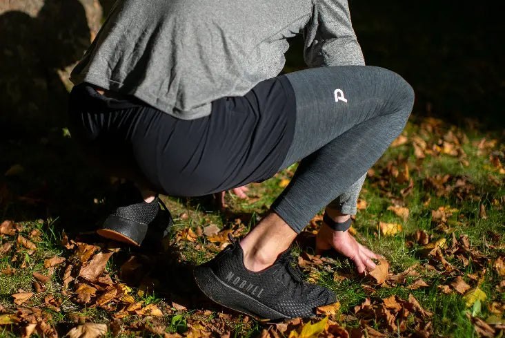 Back view of Charcoal Heather Strider tights, showing the athletic contouring and breathable fabric.