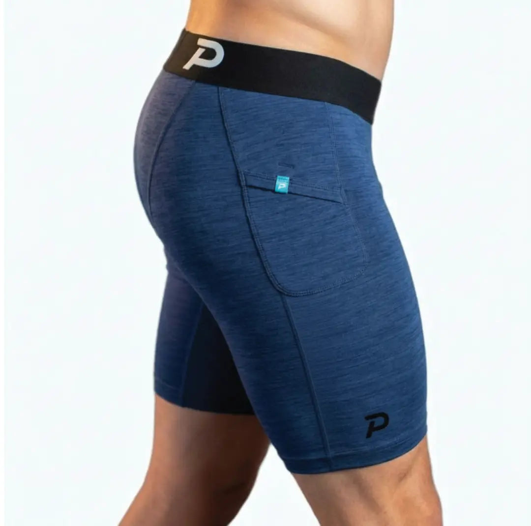 Side view of the Middy compression short on a model, highlighting the athletic fit, wide comfort waistband, and the durable, soft-touch navy SwingLoft material.