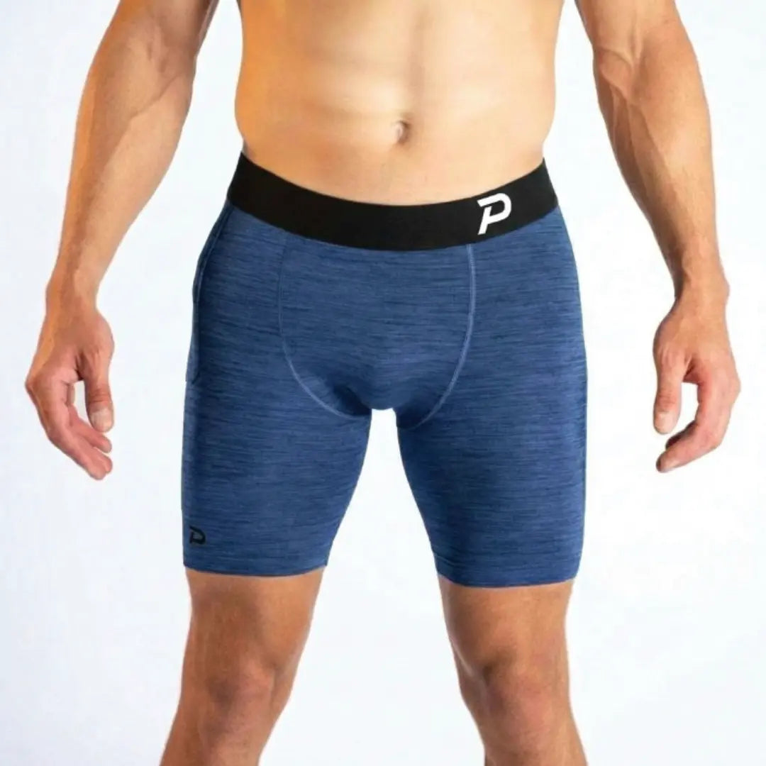 Front view of the Pacterra Middy men's compression shorts in navy blue, showing the ergonomic front panel and structured support for high-impact training.