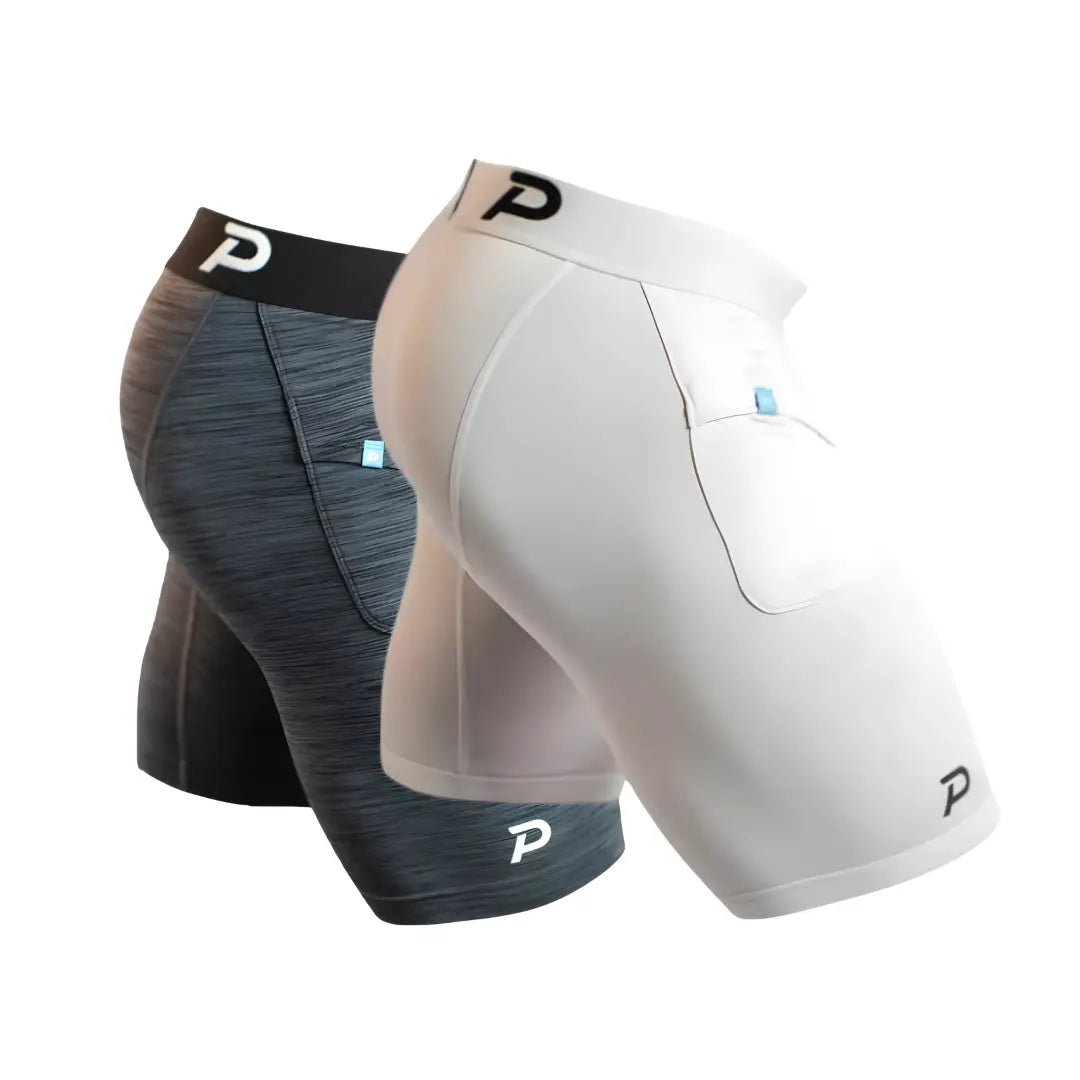 Two pairs of Pacterra Middy men's compression shorts in white and heather grey, featuring the most comfortable anti-chafe fabric and secure side pocket.