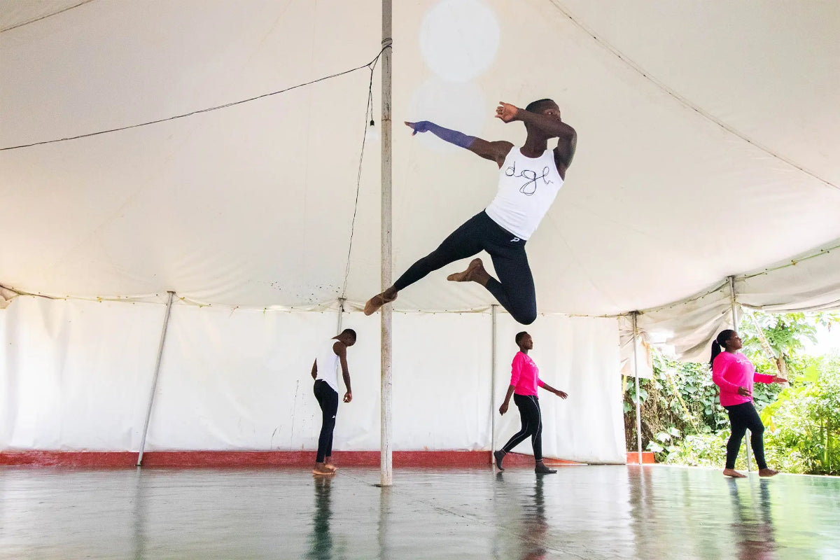 Dancers performing in Pacterra mens black compression gear as part of the MindLeaps partnership.