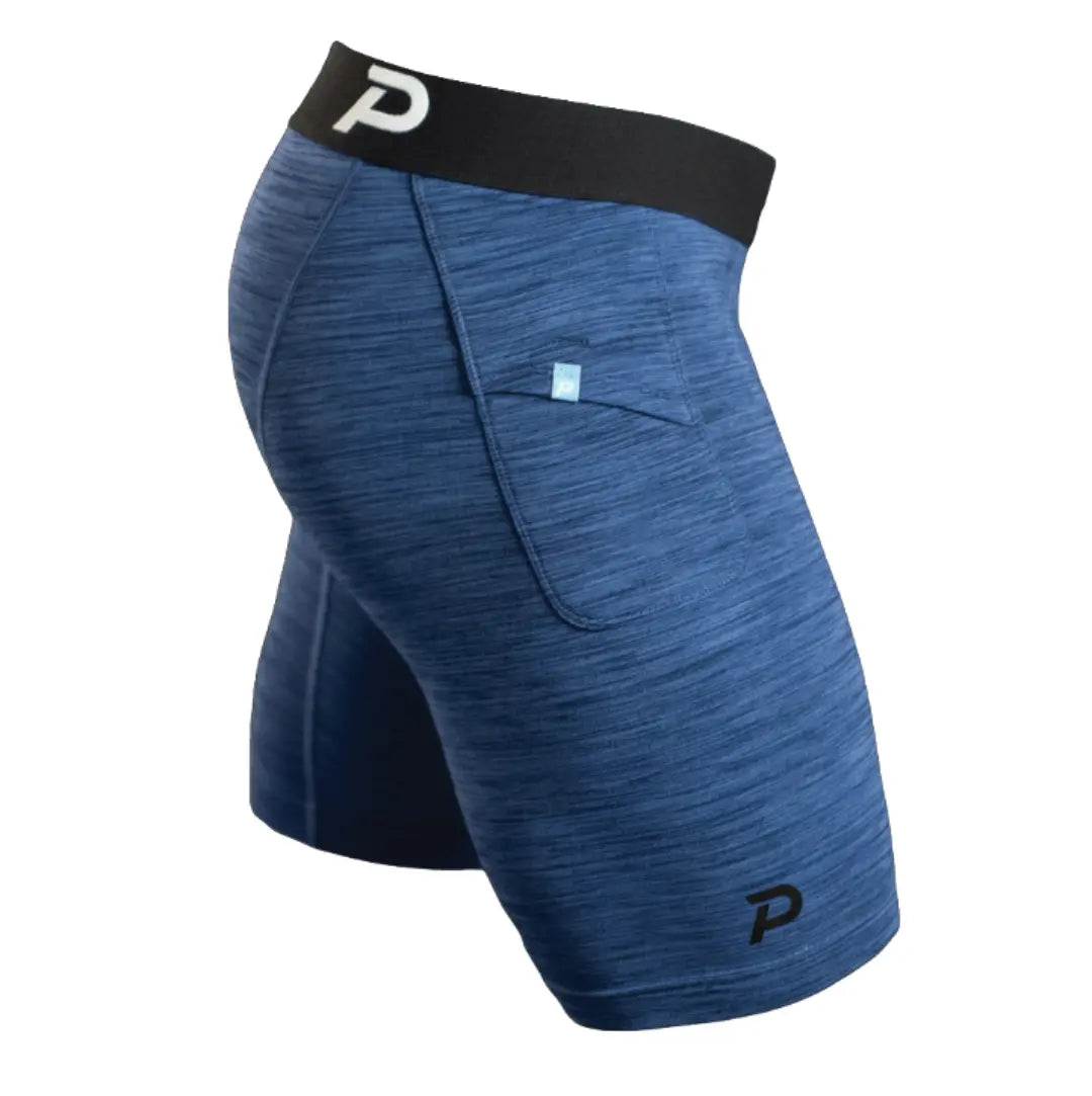 A side profile of Pacterra Athletics Middy compression shorts in navy blue, showcasing the secure side-access storage pocket and premium SwingLoft fabric texture.