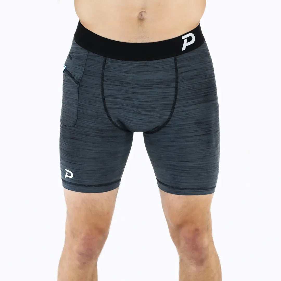 Front view of grey compression shorts highlighting the breathable moisture-wicking material and comfort waistband.